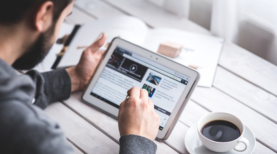 A man reads news on his tablet.