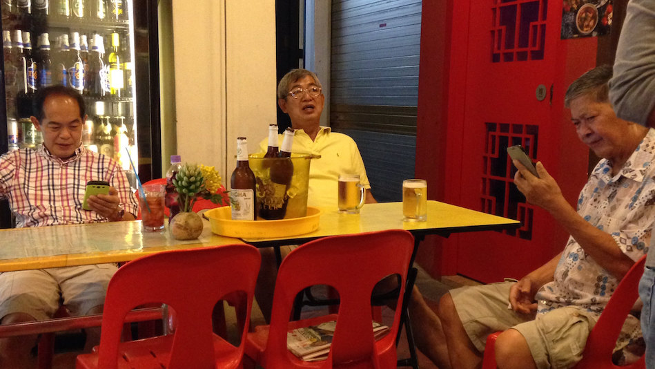 Men in Singapore with their mobile phones