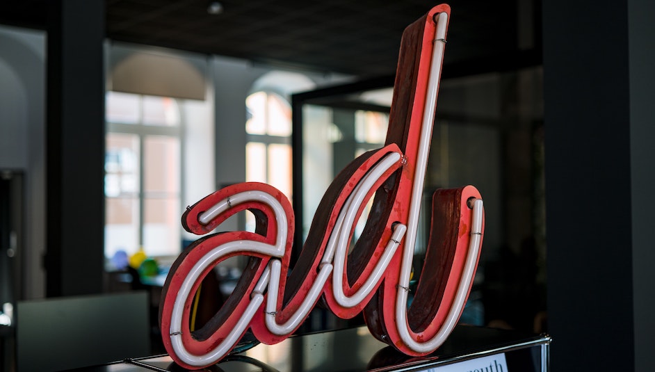 A neon ad sign. Bloomberg and other premium publishers are leveraging first-party data to cut out advertising middlemen. Photo by Julian Hochgesang