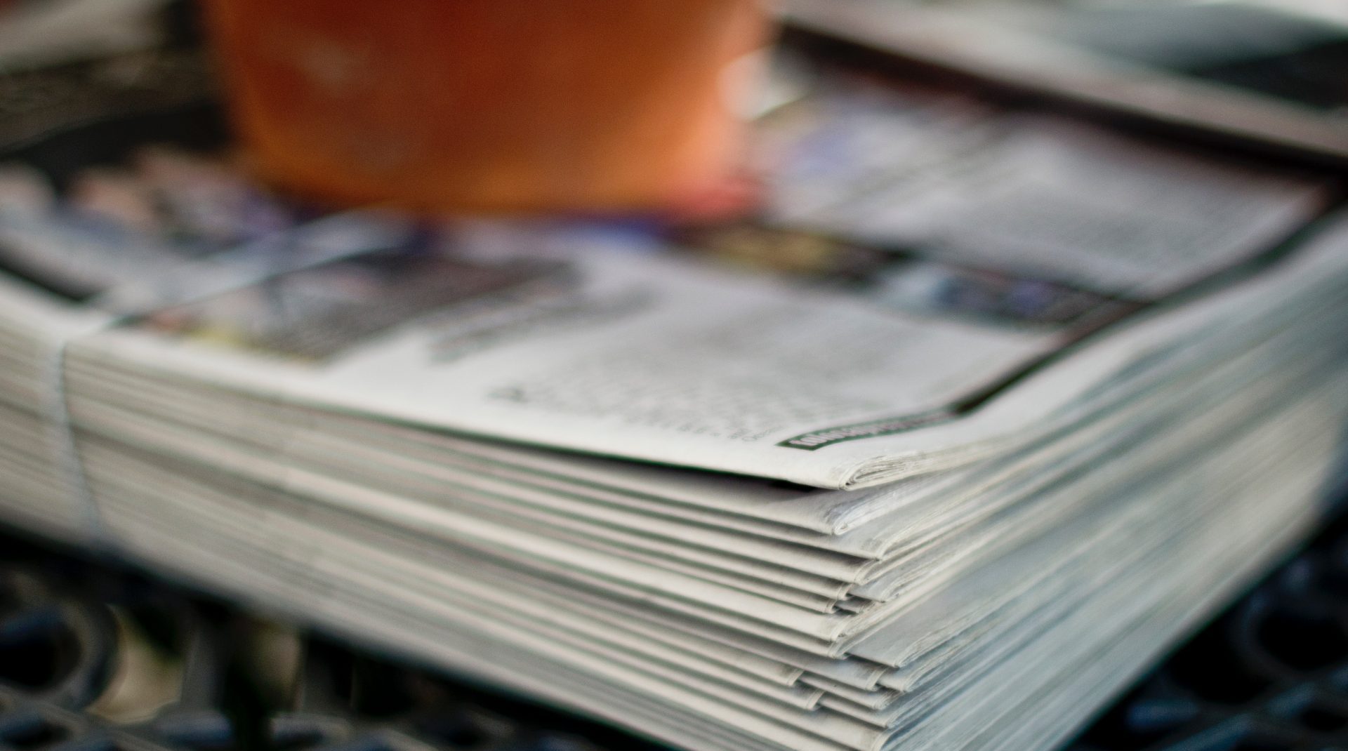 A stack of newspapers, photo by Tim Mossholder from Unsplash. 