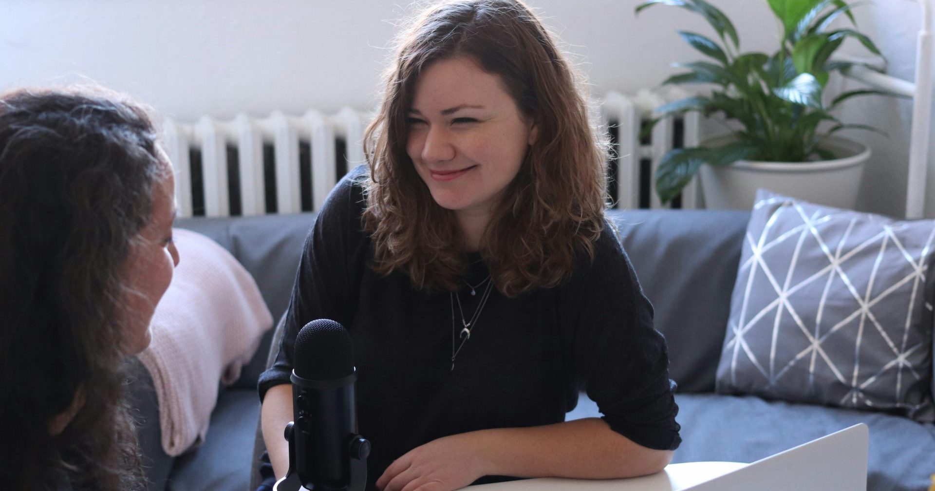 A women interviews another woman for a podcast. Publishers are finding success with audio as a way to increase engagement with users. Photo by CoWomen on Unsplash