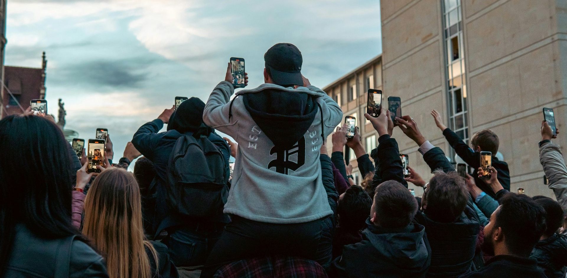 Young people in Leipzig Germany take pictures with their smartphones. There is a gap between the news experiences provided by traditional news organisations and what young audiences expect, a new report says. Photo by Victoria Prymak on Unsplash