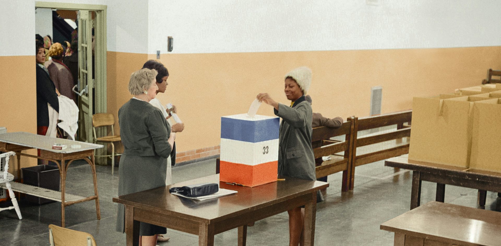 A wave of elections in 2024 offer news organisations an opportunity to reach new audiences with their journalism and increase their revenue. A black woman votes at Cardoza High School in Washington, D.C. in 1964. photo by Marion S. Trikosko, colourised by Jordan J. Lloyd. Library of Congress Prints and Photographs Division