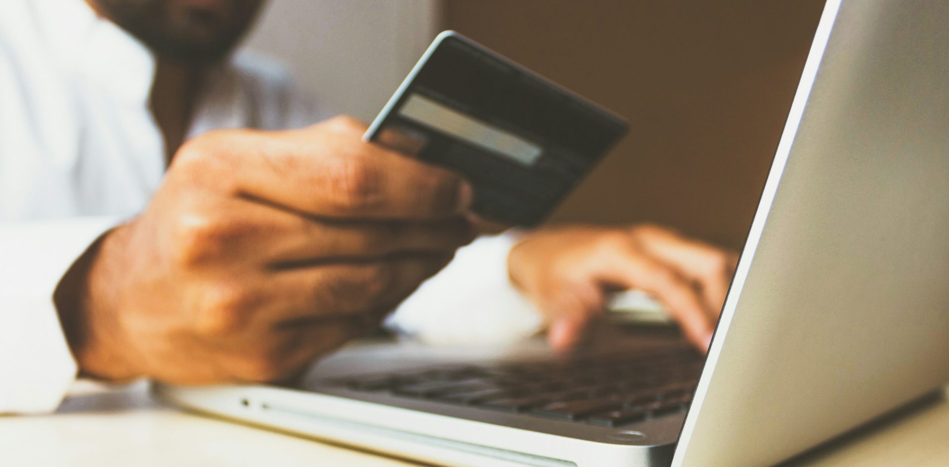 While reader revenue growth has stalled by some measures, more than a third of those surveyed by the Reuters Institute are willing to pay. A person prepares to make a purchase while seated at their laptop. Photo by Rupixen.